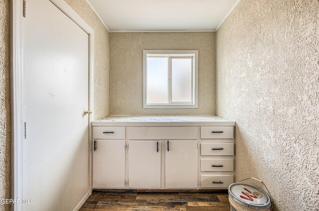 bathroom with wood finished floors and ornamental molding