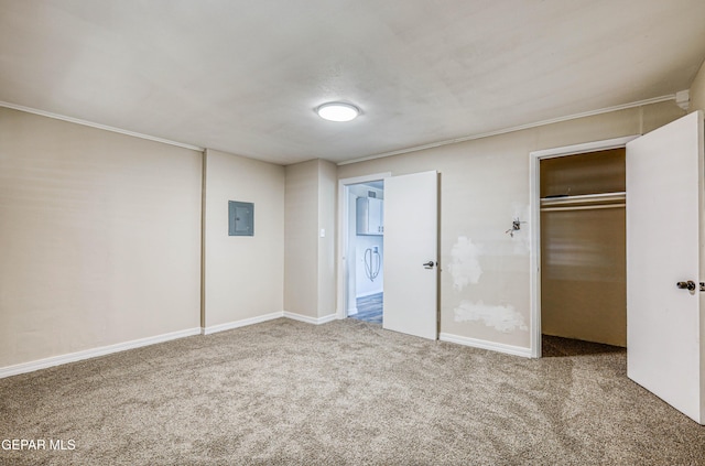 unfurnished bedroom with carpet floors, electric panel, a closet, baseboards, and ornamental molding