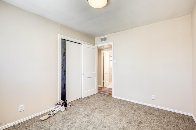 unfurnished bedroom featuring carpet flooring, a closet, and baseboards