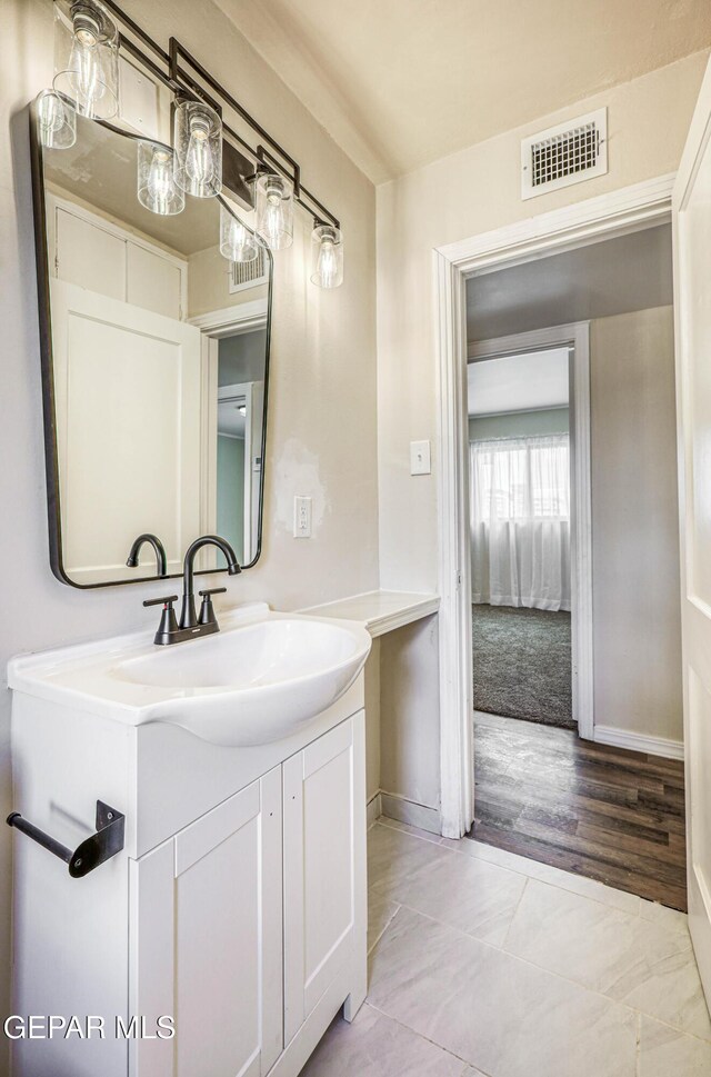 bathroom with vanity and baseboards