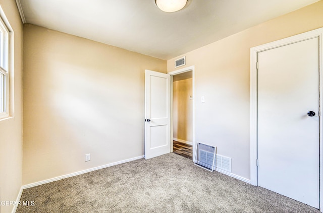 unfurnished bedroom featuring carpet and baseboards