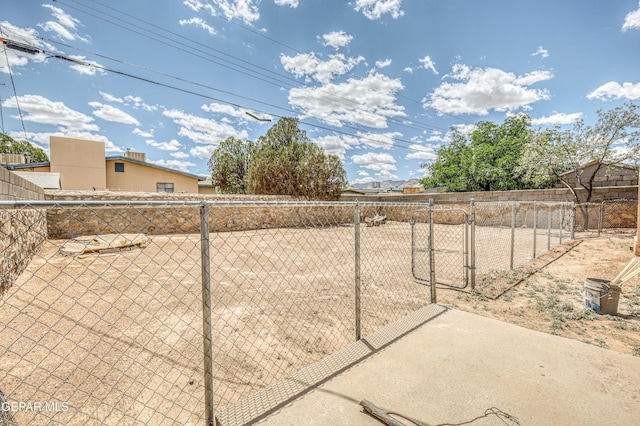 view of yard featuring fence and a gate