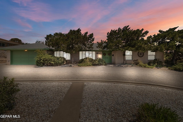 view of front of property featuring an attached garage and brick siding