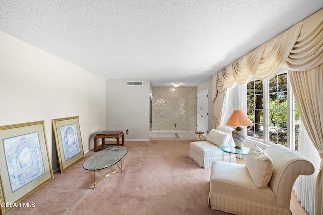 living area with carpet floors, a textured ceiling, and baseboards