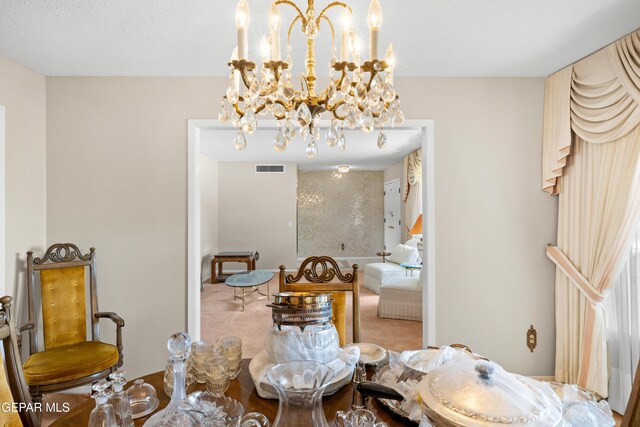 dining area featuring a chandelier and carpet