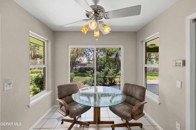 dining space featuring tile patterned floors, plenty of natural light, baseboards, and ceiling fan