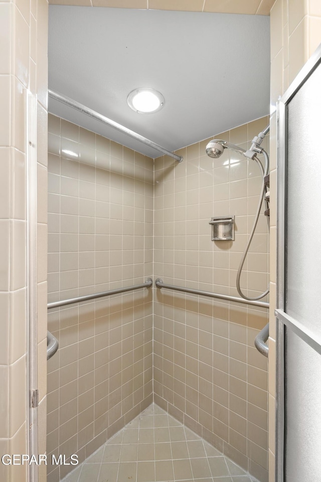 full bath featuring a shower stall