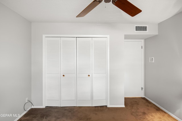 unfurnished bedroom featuring carpet floors, a closet, and baseboards