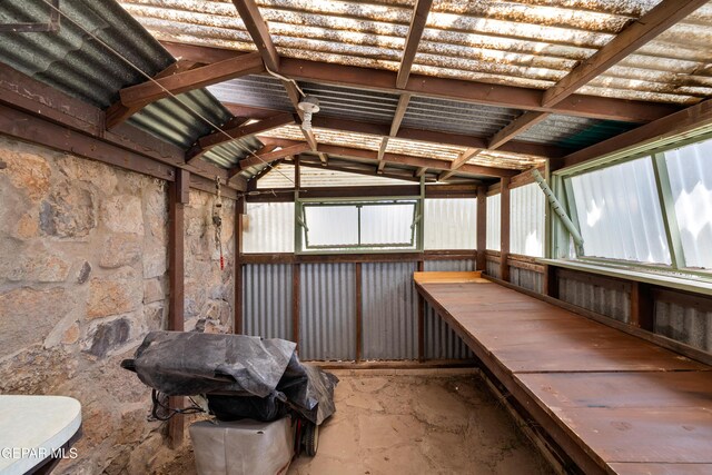 sunroom featuring vaulted ceiling