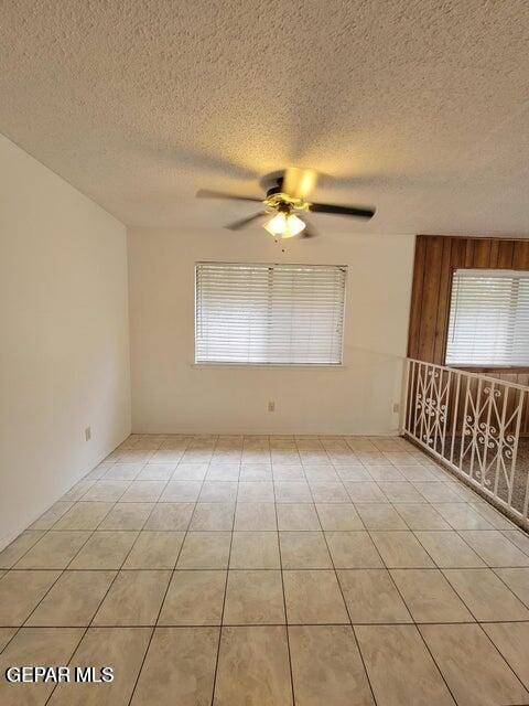 7716 Iroquois Dr, El Paso, TX 79912 - empty room with a ceiling fan, a textured ceiling, and light tile patterned flooring