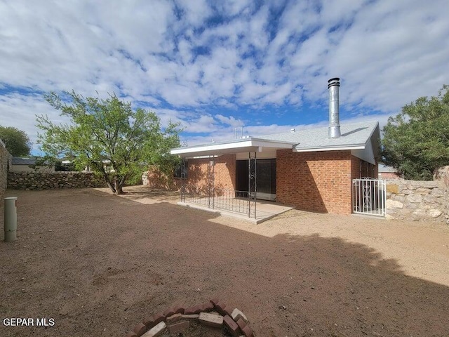 7716 Iroquois Dr, El Paso, TX 79912 - rear view of house with a patio and brick siding