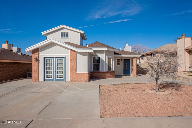 12033 Fred Carter Dr, El Paso, TX 79936 - single story home featuring brick siding, french doors, and a chimney
