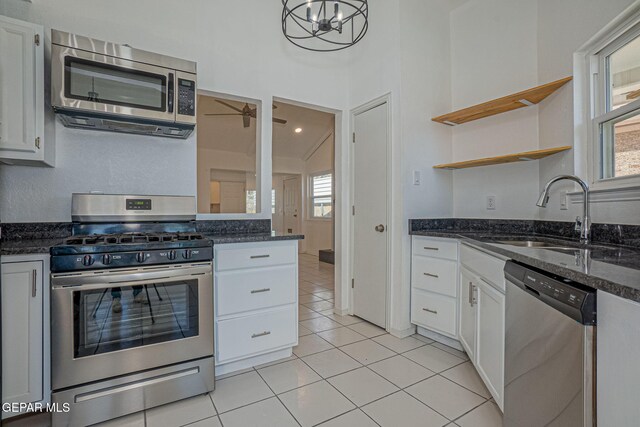 12033 Fred Carter Dr, El Paso, TX 79936 - kitchen with appliances with stainless steel finishes, a sink, open shelves, white cabinets, and light tile patterned flooring