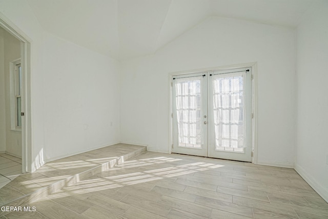 12033 Fred Carter Dr, El Paso, TX 79936 - unfurnished room featuring french doors, lofted ceiling, and light wood-type flooring
