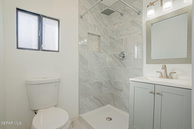 12033 Fred Carter Dr, El Paso, TX 79936 - bathroom featuring toilet, tiled shower, vanity, and marble finish flooring
