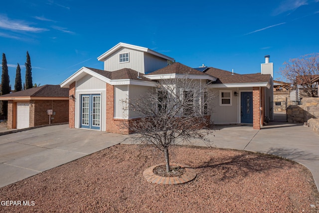 12033 Fred Carter Dr, El Paso, TX 79936 - single story home with a chimney, french doors, driveway, and brick siding