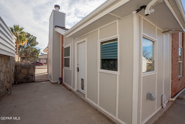 12033 Fred Carter Dr, El Paso, TX 79936 - view of home's exterior featuring a chimney and a patio area