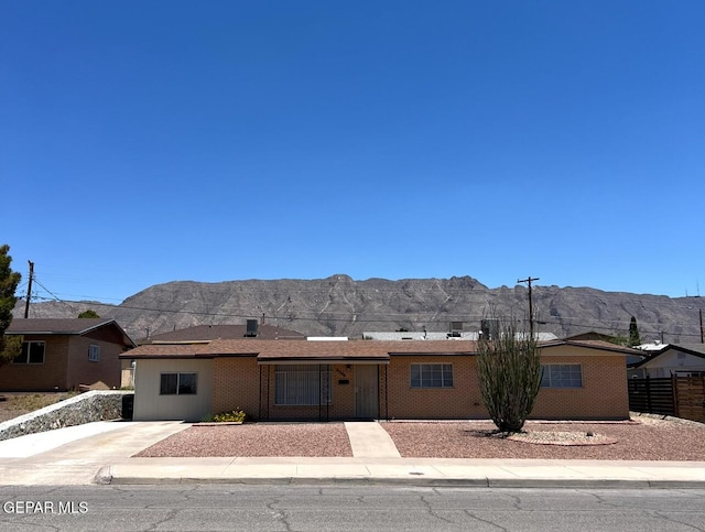 6044 Cabrillo Dr, El Paso, TX 79912 - ranch-style house featuring a mountain view, fence, and brick siding