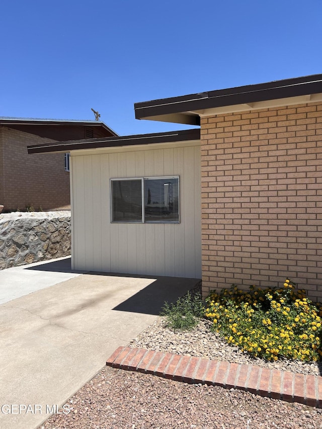 6044 Cabrillo Dr, El Paso, TX 79912 - view of side of property featuring brick siding and a patio area