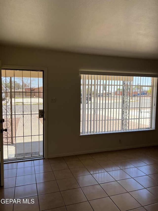6044 Cabrillo Dr, El Paso, TX 79912 - tiled empty room featuring baseboards