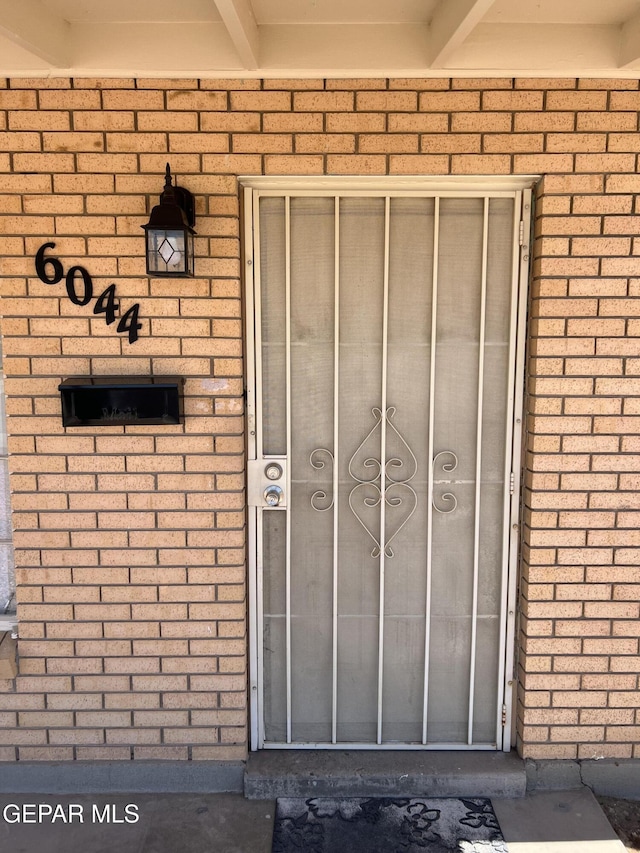 6044 Cabrillo Dr, El Paso, TX 79912 - doorway to property featuring brick siding