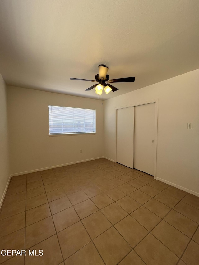 6044 Cabrillo Dr, El Paso, TX 79912 - unfurnished bedroom with a closet, light tile patterned flooring, a ceiling fan, and baseboards