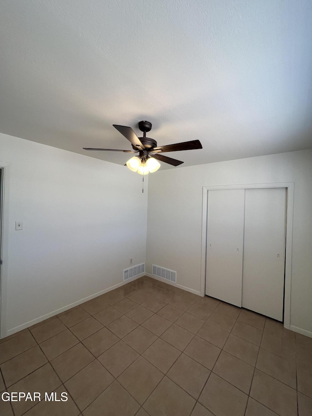 6044 Cabrillo Dr, El Paso, TX 79912 - empty room featuring light tile patterned floors, a ceiling fan, and baseboards