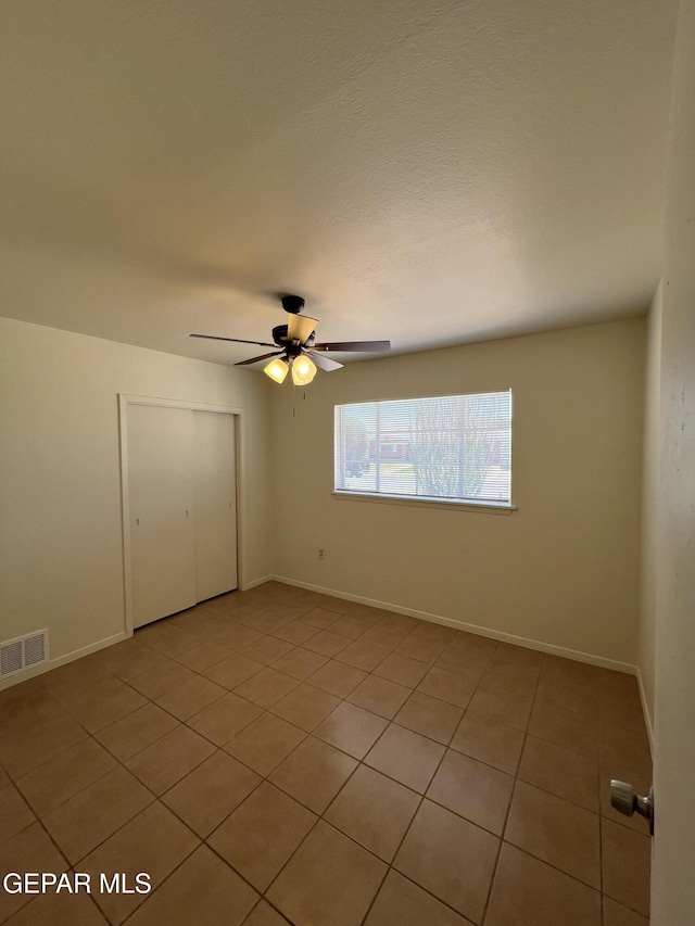 6044 Cabrillo Dr, El Paso, TX 79912 - unfurnished bedroom with light tile patterned floors, a closet, a ceiling fan, and baseboards