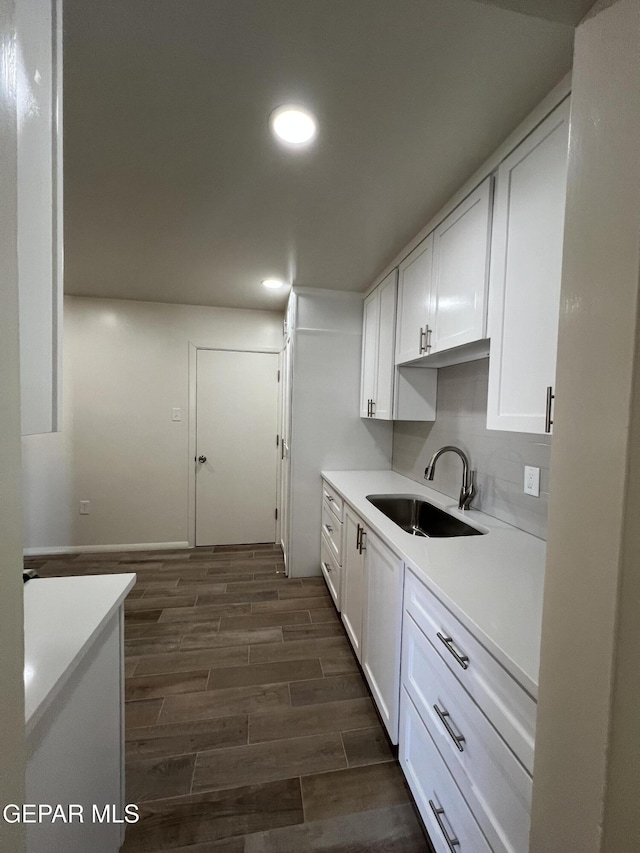 6044 Cabrillo Dr, El Paso, TX 79912 - kitchen featuring a sink, recessed lighting, dark wood-type flooring, white cabinets, and light countertops