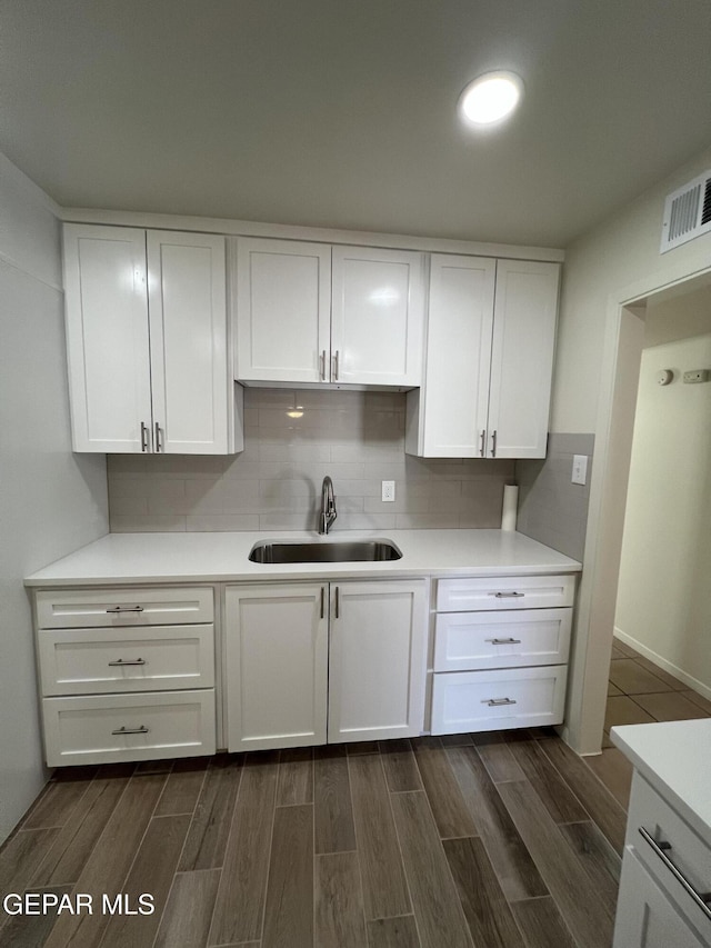 6044 Cabrillo Dr, El Paso, TX 79912 - kitchen featuring a sink, dark wood finished floors, white cabinetry, and light countertops