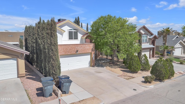 12572 Paseo Alegre Dr, El Paso, TX 79928 - view of front of house featuring a garage, concrete driveway, brick siding, and stucco siding