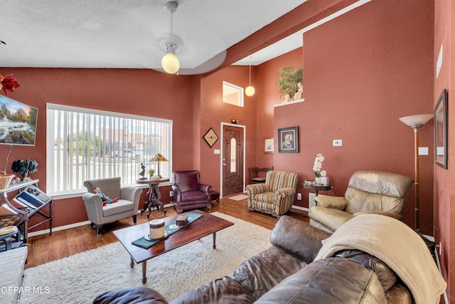 12273 El Greco Cir, El Paso, TX 79936 - living room featuring wood finished floors, a textured ceiling, baseboards, a textured wall, and a ceiling fan