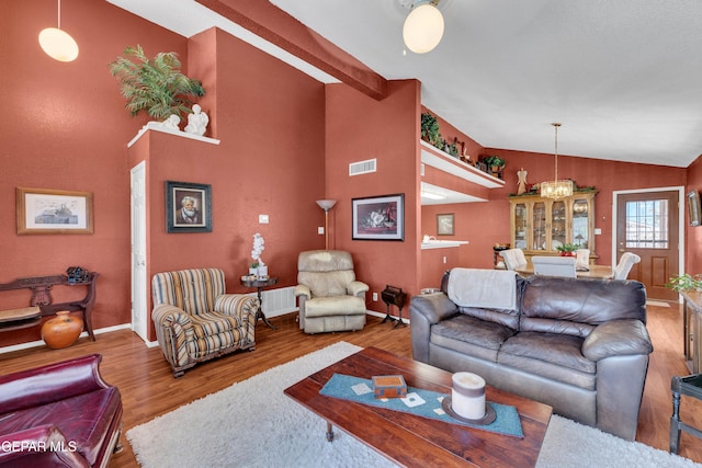 12273 El Greco Cir, El Paso, TX 79936 - living room with vaulted ceiling, wood finished floors, baseboards, and a chandelier