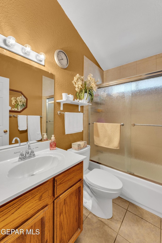 12273 El Greco Cir, El Paso, TX 79936 - full bath with tile patterned floors, lofted ceiling, a textured wall, vanity, and bath / shower combo with glass door
