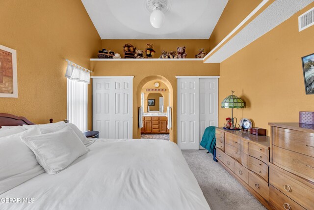12273 El Greco Cir, El Paso, TX 79936 - bedroom featuring arched walkways, light colored carpet, and multiple closets