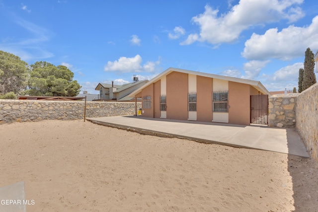 12273 El Greco Cir, El Paso, TX 79936 - rear view of property with stucco siding and a gate