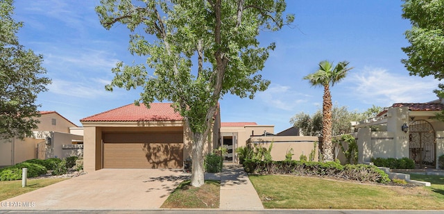 1114 Los Jardines Cir, El Paso, TX 79912 - mediterranean / spanish house with a garage, stucco siding, a tile roof, and driveway