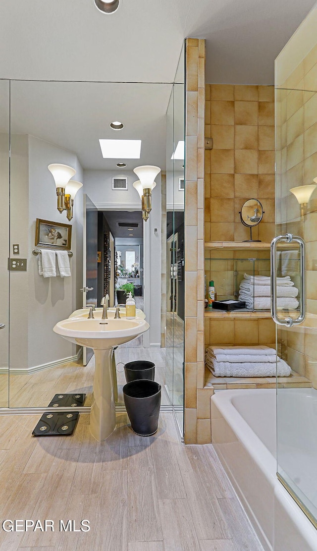 1114 Los Jardines Cir, El Paso, TX 79912 - bathroom with a tub, wood finished floors, and a shower