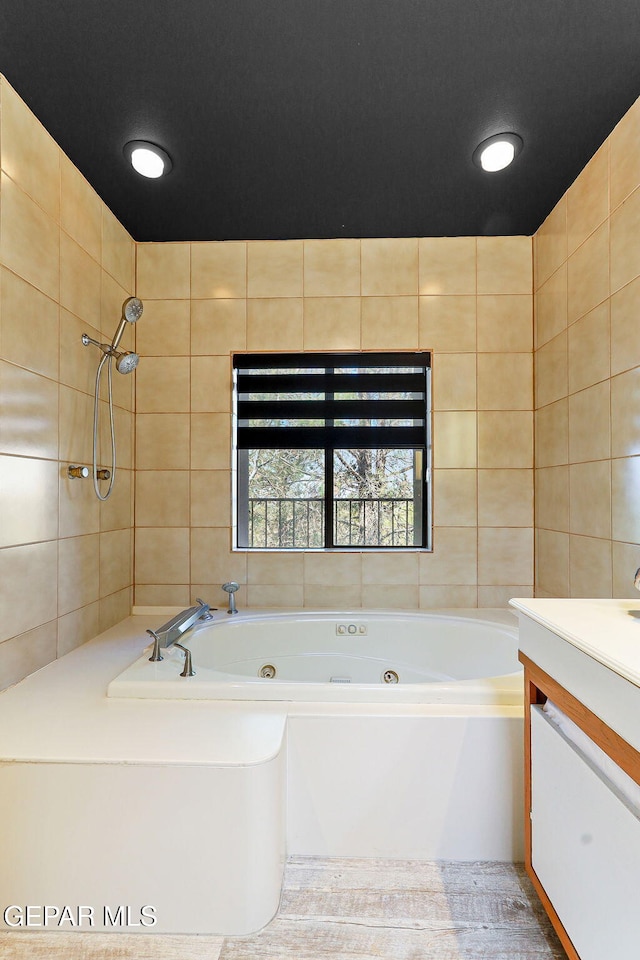 1114 Los Jardines Cir, El Paso, TX 79912 - bathroom with tile walls, a whirlpool tub, and vanity