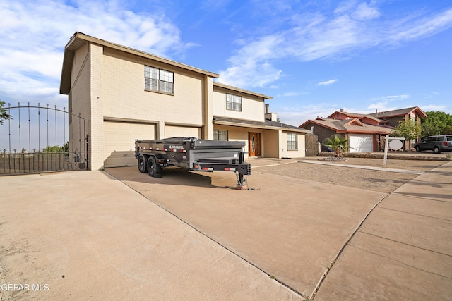 1393 Vista Granada Dr, El Paso, TX 79936 - back of property with a garage, concrete driveway, brick siding, and a gate