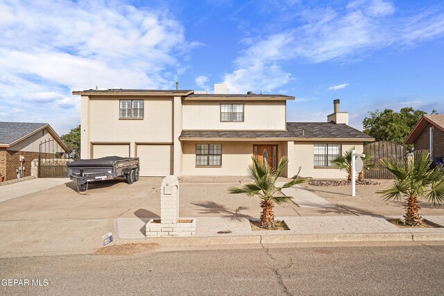 1393 Vista Granada Dr, El Paso, TX 79936 - view of front facade with driveway, a chimney, an attached garage, fence, and a gate