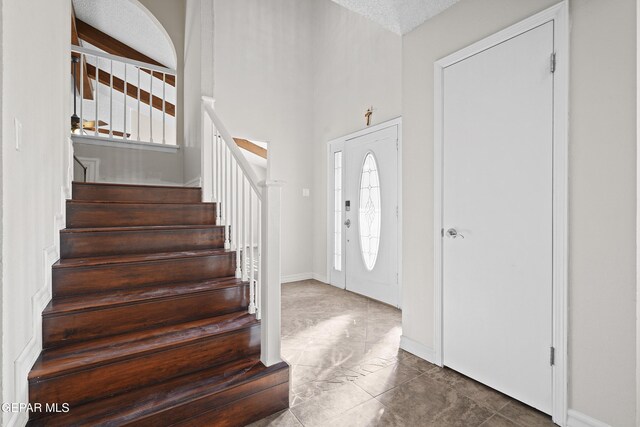 1393 Vista Granada Dr, El Paso, TX 79936 - entryway featuring stairway, baseboards, and a textured ceiling