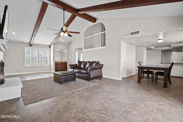 1393 Vista Granada Dr, El Paso, TX 79936 - living room featuring a ceiling fan, baseboards, a fireplace, high vaulted ceiling, and beamed ceiling