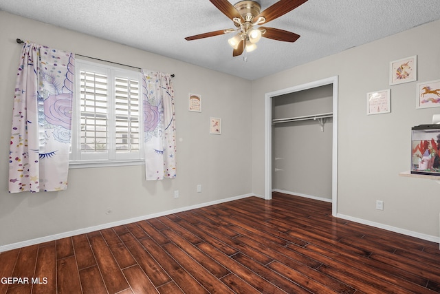 1393 Vista Granada Dr, El Paso, TX 79936 - unfurnished bedroom with wood finished floors, a textured ceiling, baseboards, a closet, and ceiling fan