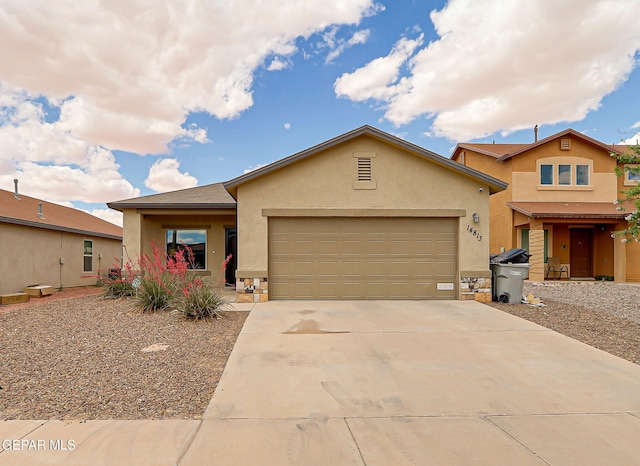 view of front of property with stucco siding, a garage, and driveway