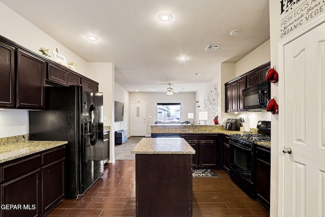 kitchen with black appliances, a center island, ceiling fan, a peninsula, and dark brown cabinets