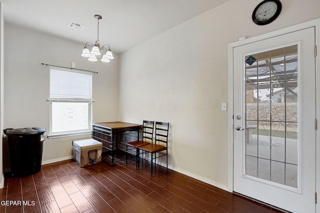 dining space with baseboards, a chandelier, and dark wood-style floors