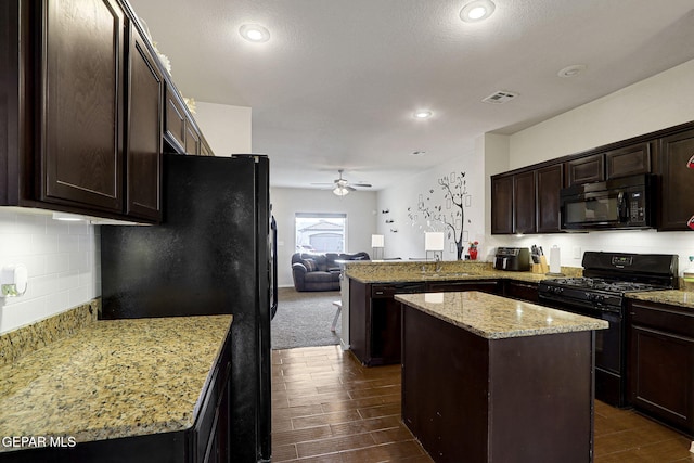 kitchen featuring black appliances, a ceiling fan, a peninsula, dark brown cabinets, and open floor plan
