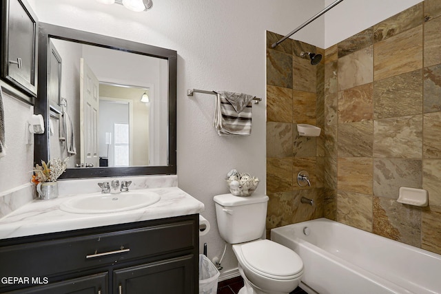 full bathroom featuring shower / tub combination, toilet, vanity, and a textured wall