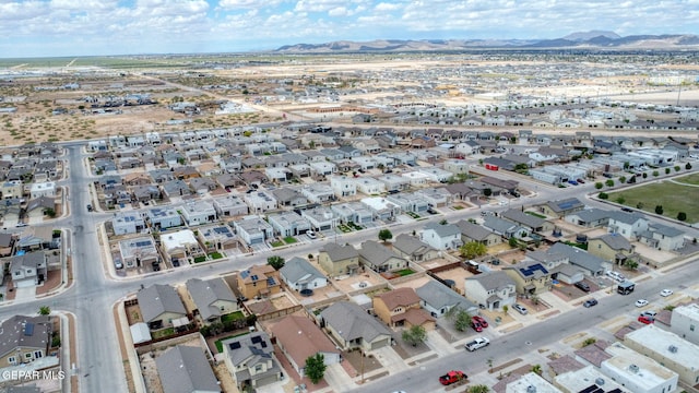 aerial overview of property's location featuring a mountainous background and nearby suburban area